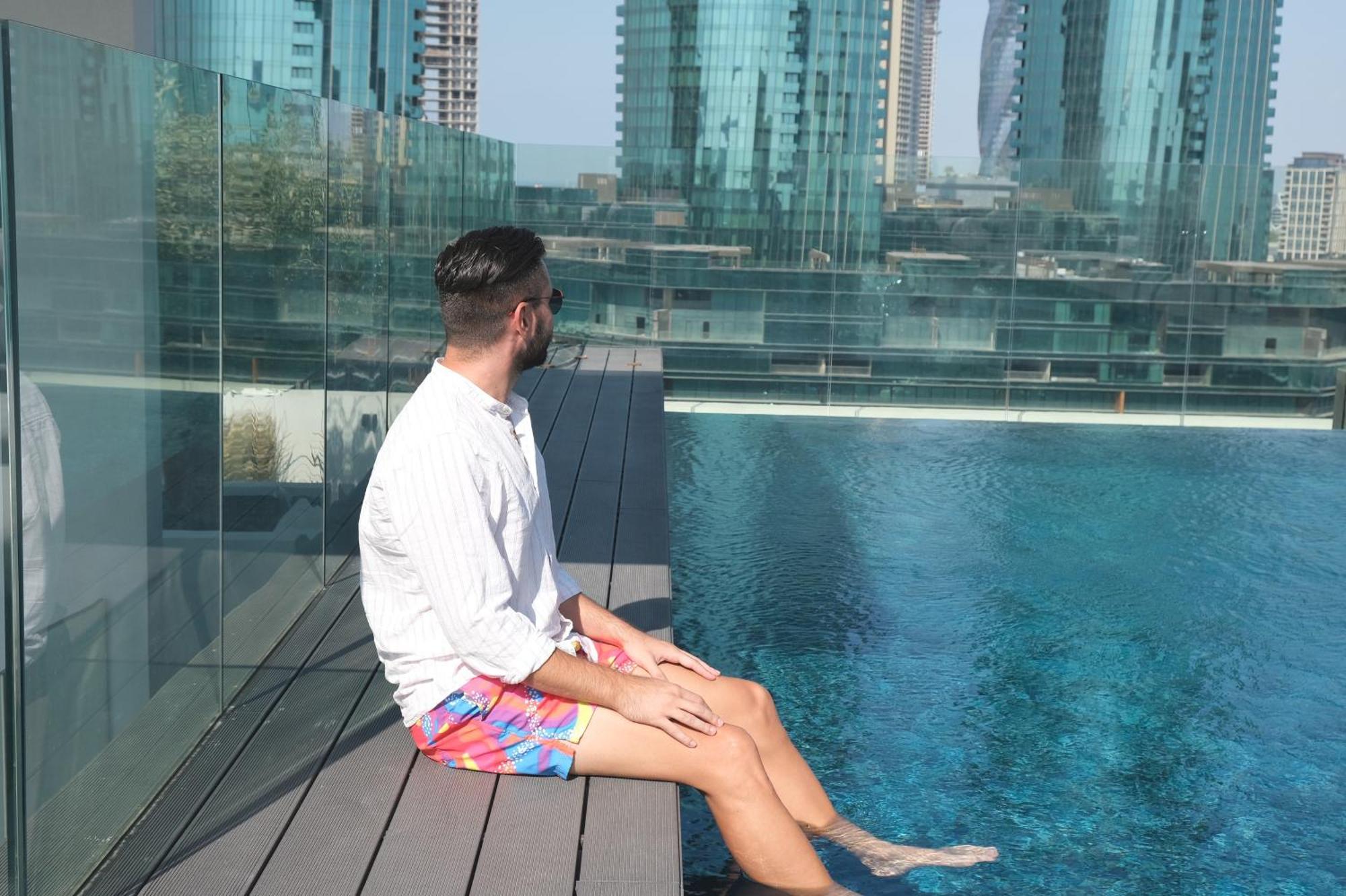 Charthouse Bahrain Hotell Manama Exteriör bild A man sitting on the edge of a pool